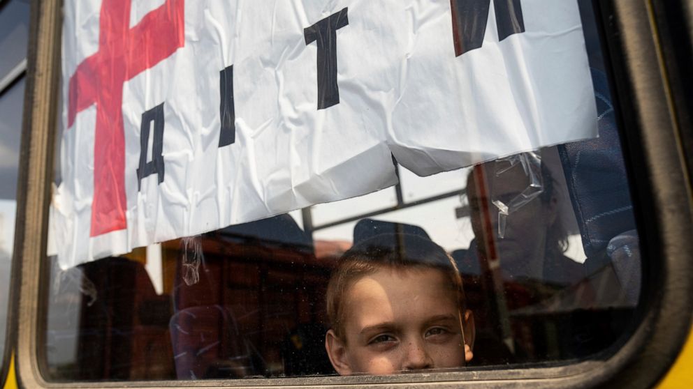 A boy from Siversk looks though the window of a bus during evacuation near Lyman, Ukraine, Wednesday, May 11, 2022. (AP Photo/Evgeniy Maloletka)