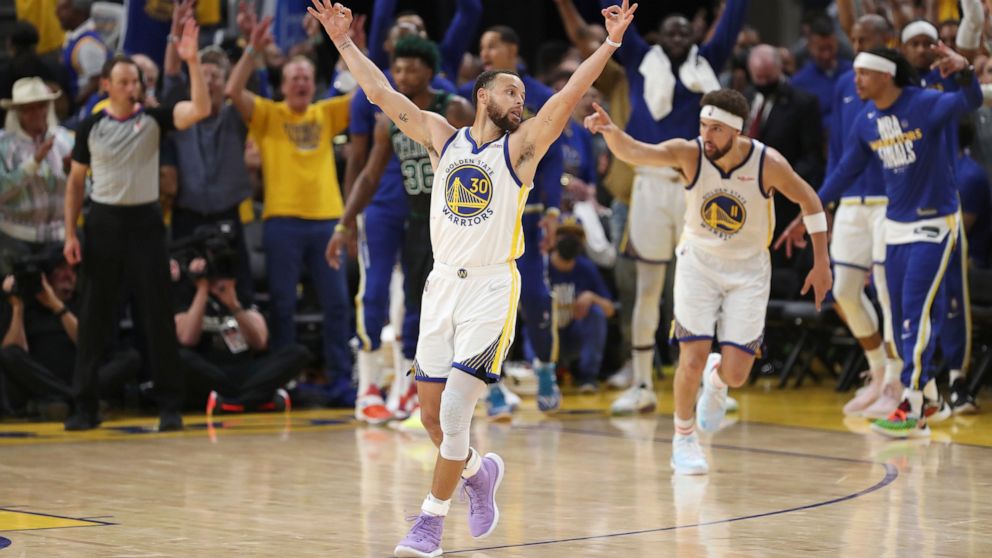 Golden State Warriors guard Stephen Curry (30) celebrates after guard Klay Thompson, right, shot a 3-point basket during the second half of Game 5 of basketball's NBA Finals against the Boston Celtics in San Francisco, Monday, June 13, 2022. (AP Phot