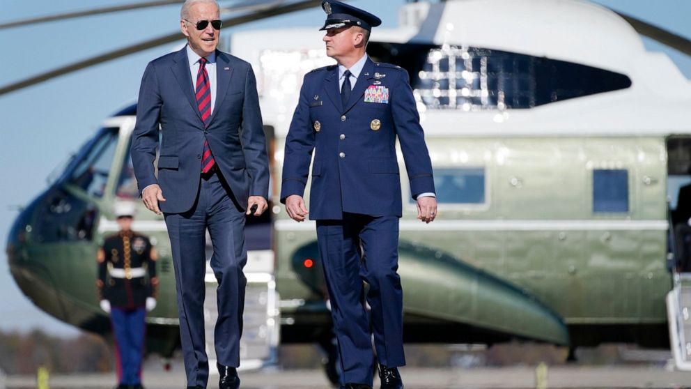 President Joe Biden, escorted by Colonel Matthew Jones, Commander, 89th Airlift Wing, walks to board Air Force One for a trip to New Hampshire to promote his "Build Back Better" agenda, Tuesday, Nov. 16, 2021, in Andrews Air Force Base, Md. (AP Photo