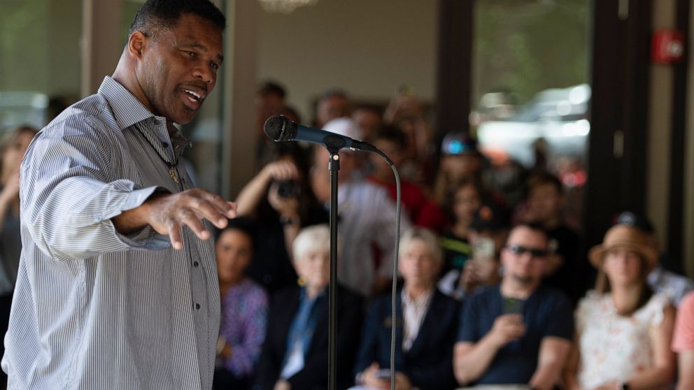 FILE - Republican Senate candidate Herschel Walker speaks to supporters during a campaign stop, May 14, 2022, in Ellijay, Ga. Walker boasts of his charity work helping members of the military who struggle with mental health. The football legend and l