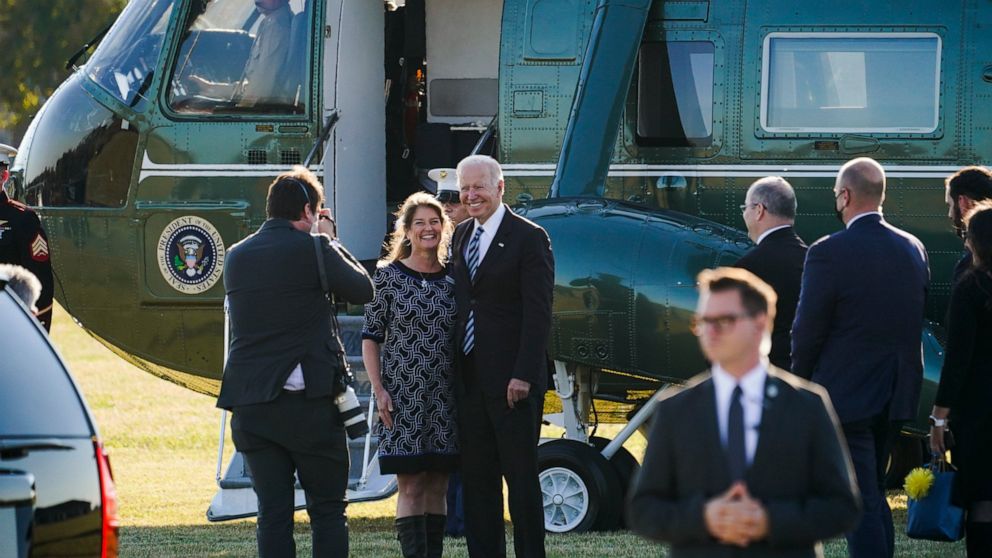 President Joe Biden poses for a photo with Cathy Kanefsky, President and CEO, Food Bank of Delaware, before boarding Marine One in Milford, Del., Wednesday, Nov. 10, 2021, to travel to Baltimore, Md., to tour the Port of Baltimore after attending the