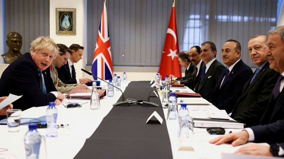British Prime Minister Boris Johnson, left, and Turkey's President Tayyip Erdogan attend a bilateral meeting during a NATO summit on Russia's invasion of Ukraine, at the alliance's headquarters in Brussels, Thursday March 24, 2022. (Henry Nicholls/Po