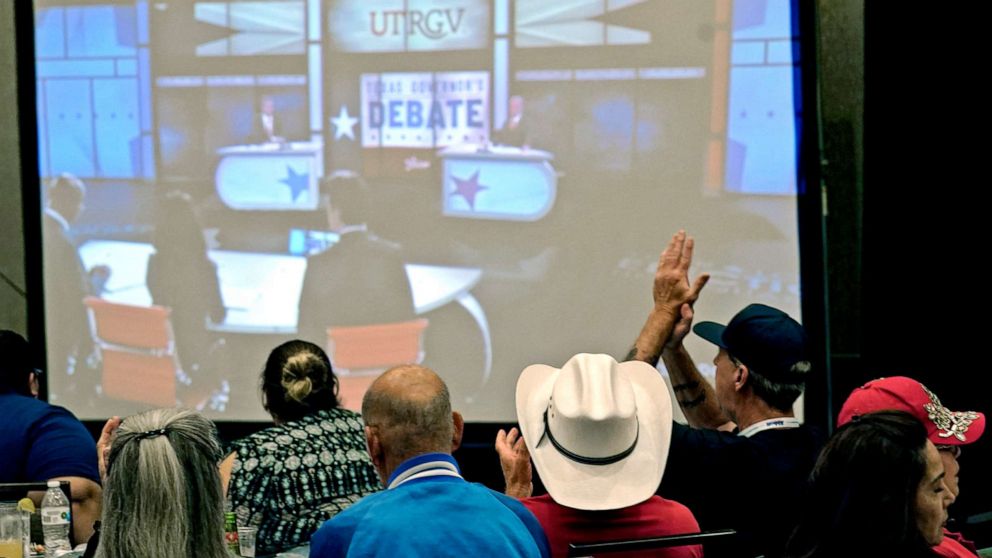 PHOTO: Supporters of Texas Gov. Greg Abbott watch his debate with Texas Democratic gubernatorial candidate Beto O'Rourke, Sept. 30, 2022, in McAllen, Texas. 