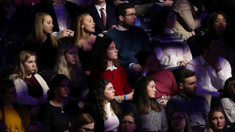 PHOTO: Audience members watch as Democratic presidential candidates arrive for a Democratic presidential primary debate at St. Anselm College, Feb. 7, 2020 in Manchester, N.H.