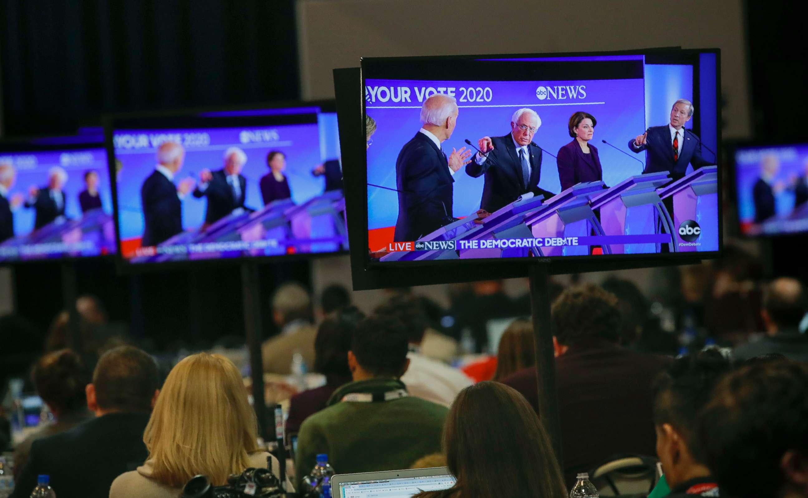 PHOTO: Members of the media watch the broadcast of the Democratic presidential primary debate, Feb. 7, 2020, at Saint Anselm College in Manchester, N.H.