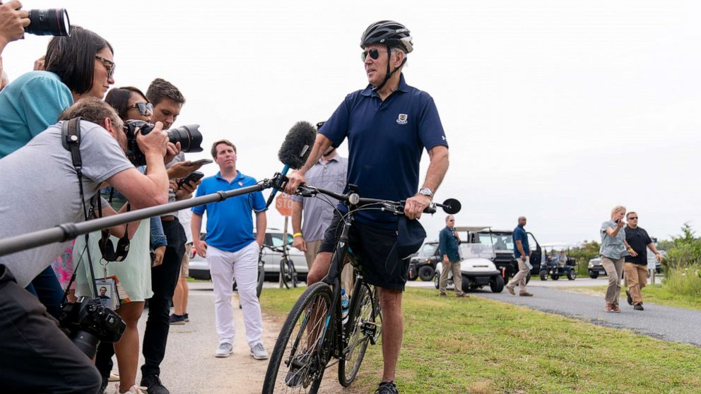 PHOTO: President Joe Biden speaks to members of the media as he goes on a bike ride in Gordons Pond State Park in Rehoboth Beach, Del., July 10, 2022. 