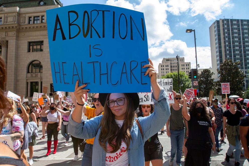 PHOTO: Women attend a march to protest new reproductive rights law in Texas which effectively bans abortions after six weeks, in Dallas Texas on Oct. 2, 2021.