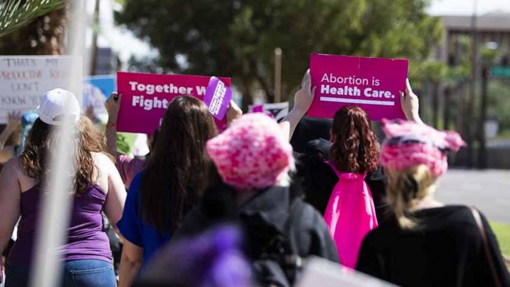 PHOTO: A Planned Parenthood sign is held at a march in support of abortion rights on Washington Street in Phoenix, Oct. 8, 2022.