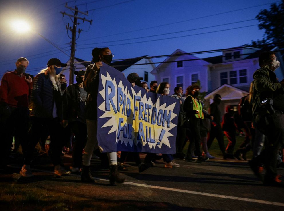 PHOTO: Demonstrators march following a vigil outside Supreme Court Justice Samuel Alito's home in Alexandria, Va., May 9, 2022.