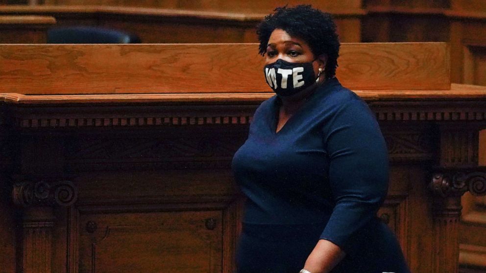 PHOTO: Democrat Stacey Abrams, walks on Senate floor before of members of Georgia's Electoral College cast their votes at the state Capitol, Dec. 14, 2020, in Atlanta.