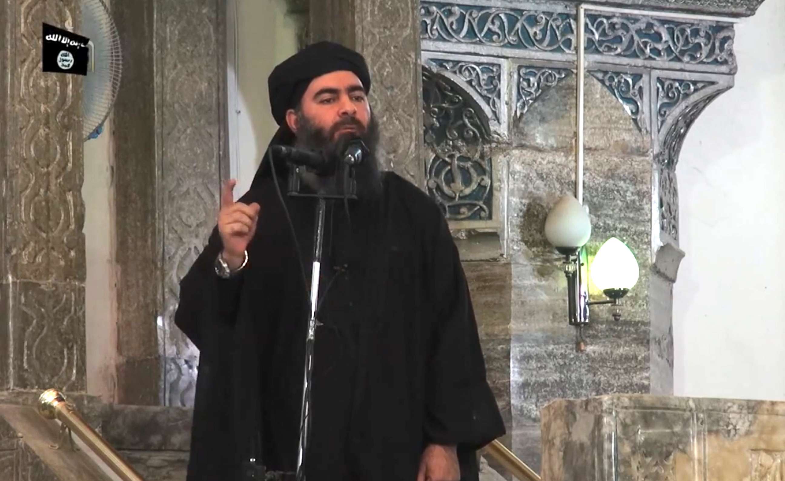 PHOTO: An image grab taken from a propaganda video released, July 5, 2014, by al-Furqan Media allegedly shows the leader of the Islamic State jihadist group, Abu Bakr al-Baghdadi, aka Caliph Ibrahim, adressing Muslim worshippers at a mosque in Mosul.