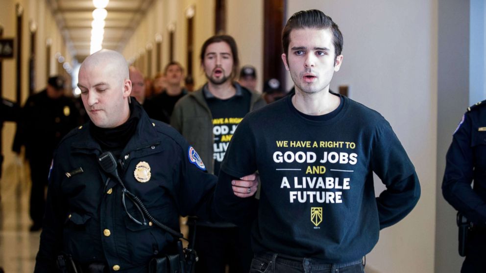 Activists with the Sunrise Movement are arrested after protesting at Senate Majority Leader Mitch McConnell's office in the Russell Senate building on Capitol Hill in Washington, DC, Feb. 25, 2019.
