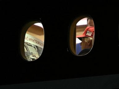 Trump photographed looking over 'Kennedy Center DEMOLISHED' placard