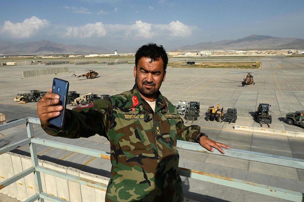 PHOTO: An Afghan National Army soldier takes a selfie with his mobile phone inside the Bagram US air base after all US and NATO troops left, north of Kabul, July 5, 2021. 