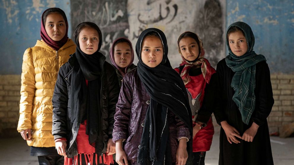 PHOTO: Afghan schoolgirls pose for a photo in a classroom in Kabul, Afghanistan, on Dec. 22, 2022.