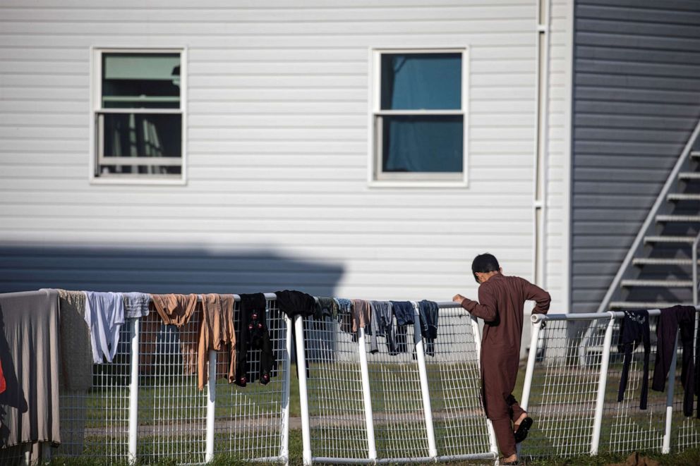 PHOTO: An Afghan refugee stands outside temporary housing at Fort McCoy U.S. Army base, in Wisconsin, Sept. 30, 2021.