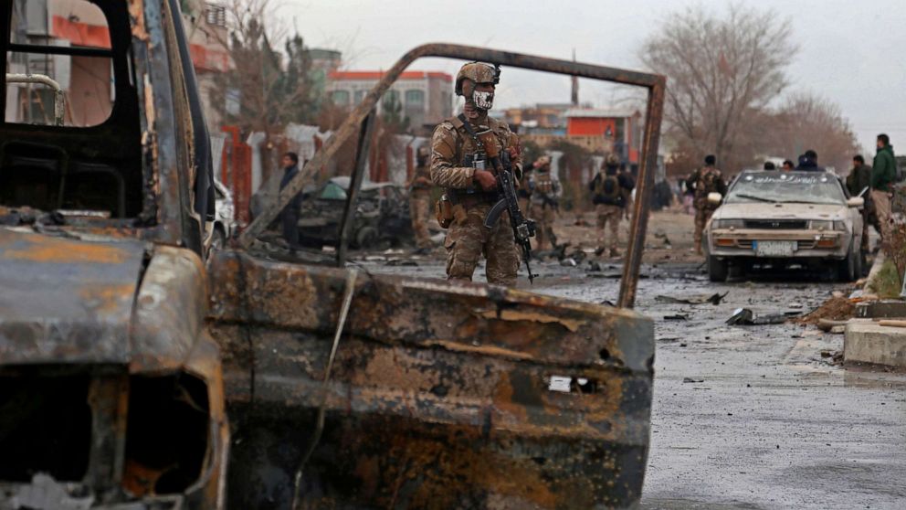 PHOTO: A member of Afghan security force stands guard at the site of an attack in Kabul on December 20, 2020. 