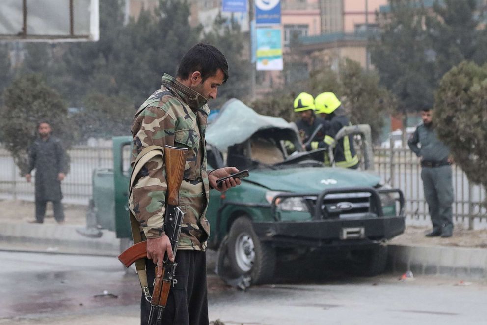 PHOTO: Policemen arrive at a site of a bomb blast which killed at least two people and injured five others, in Kabul, Feb. 21, 2021. 