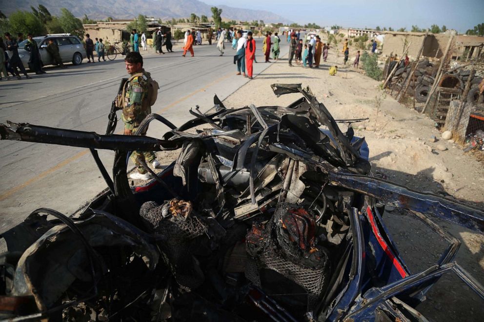 PHOTO: Afghan security officials inspect the scene of a road side bomb blast that killed six civilians on the outskirts of Jalalabad, Afghanistan, July 21, 2021.