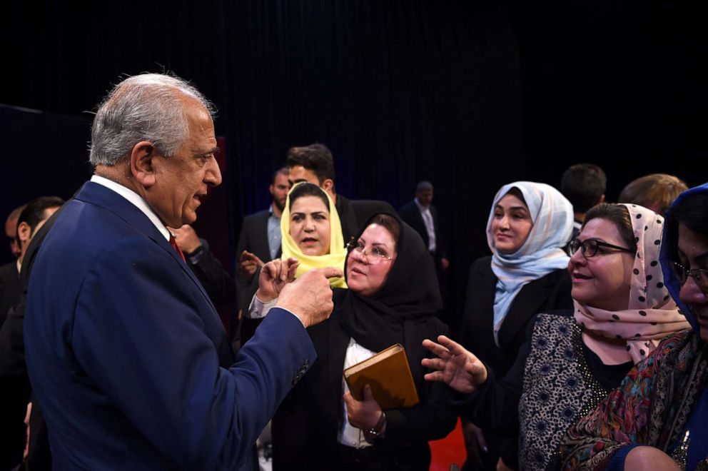 PHOTO:US special representative for Afghan peace and reconciliation Zalmay Khalilzad (L) interacts with the audience after a forum talk with Afghan director of TOLO news Lotfullah Najafizada, April 28, 2019.