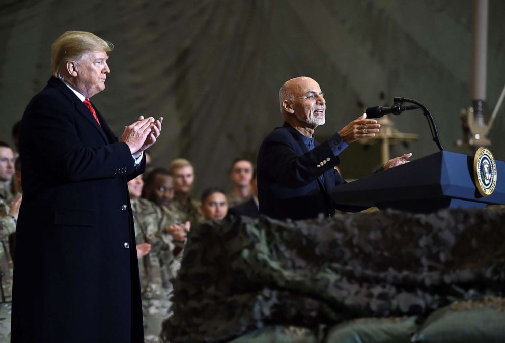 PHOTO: Afghan's President Ashraf Ghani speaks to the troops as President Donald Trump listens  during a surprise Thanksgiving day visit at Bagram Air Field, Nov. 28, 2019, in Afghanistan.
