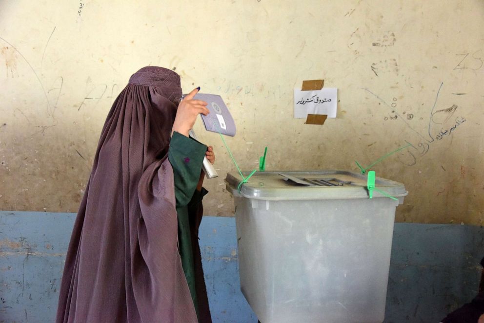 PHOTO: An Afghan woman voter casts her ballot at a polling center for the country's legislative election in Kandahar province, Oct. 27,2018. 