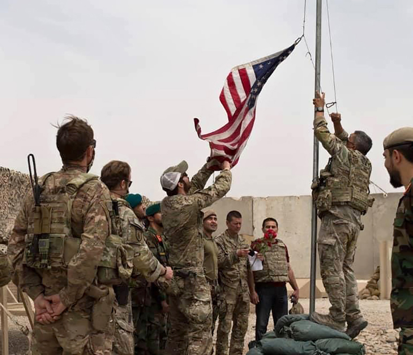 PHOTO: A U.S. flag is lowered as American and Afghan soldiers attend a handover ceremony from the U.S. Army to the Afghan National Army, at Camp Anthonic, in Helmand province, southern Afghanistan, May 2, 2021.