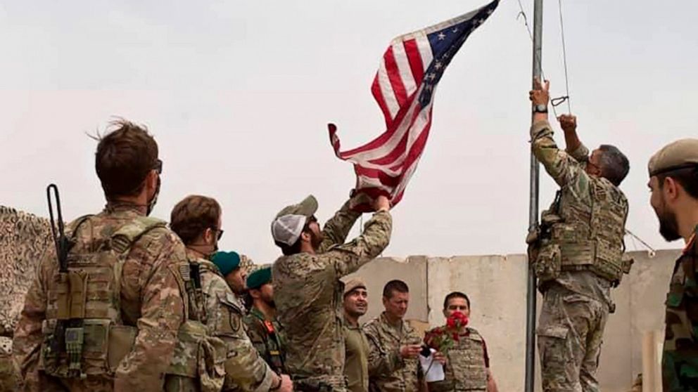 PHOTO: A U.S. flag is lowered as American and Afghan soldiers attend a handover ceremony from the U.S. Army to the Afghan National Army, at Camp Anthonic, in Helmand province, southern Afghanistan, May 2, 2021.