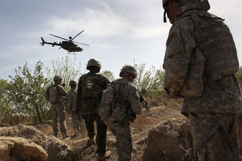 PHOTO: In this March 15, 2010, file photo, U.S. and Afghan Army soldiers maneuver on patrol with air support at Howz-e-Madad in Kandahar province, Afghanistan.