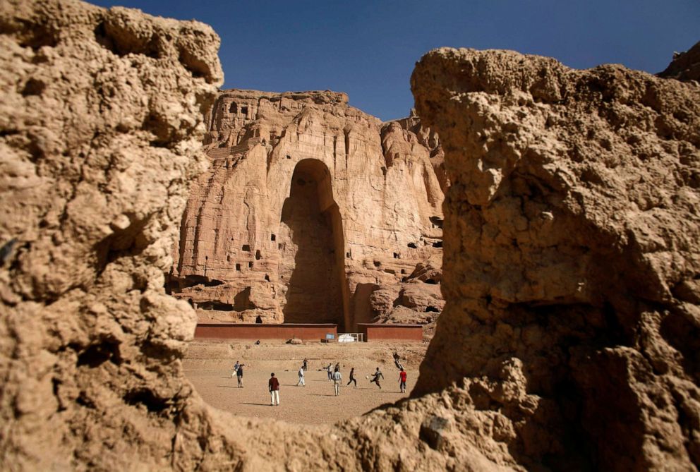 PHOTO: Afghan boys play soccer in front of the gaping niche where a giant Buddha statue used to stand in the central town of Bamiyan, April 13, 2007. The Taliban destroyed two of the statues in 2001. 