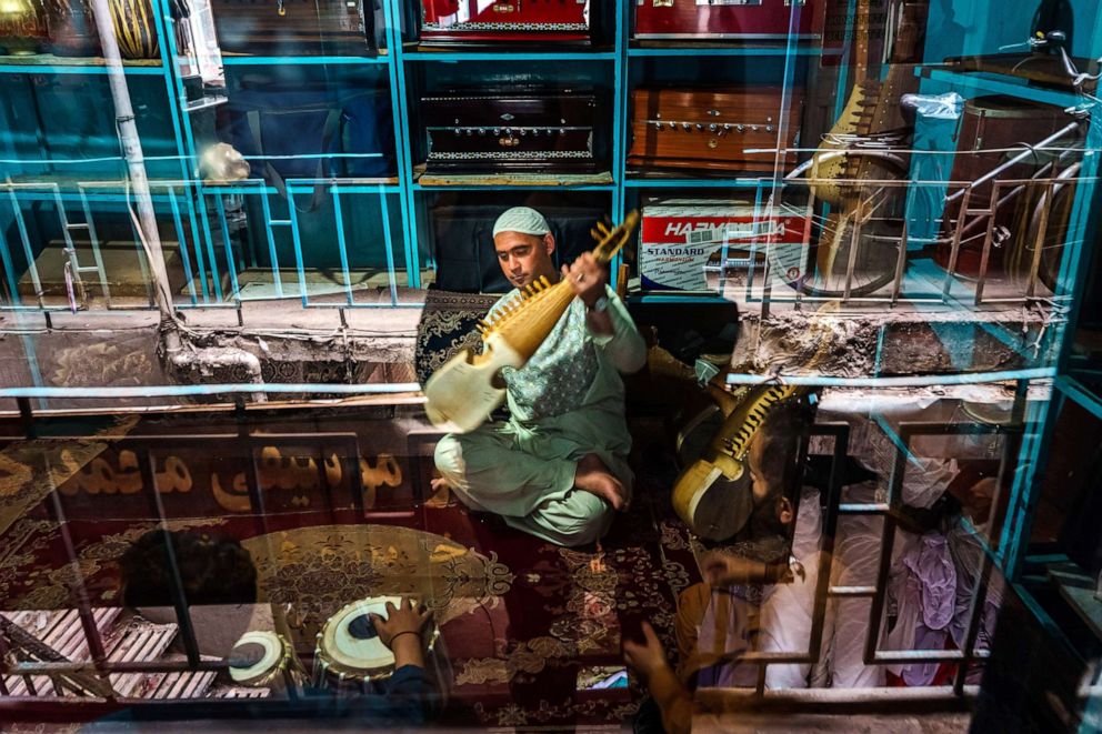 PHOTO: A musician practices with a rubab inside a music workshop in Kabul, May 2, 2021.