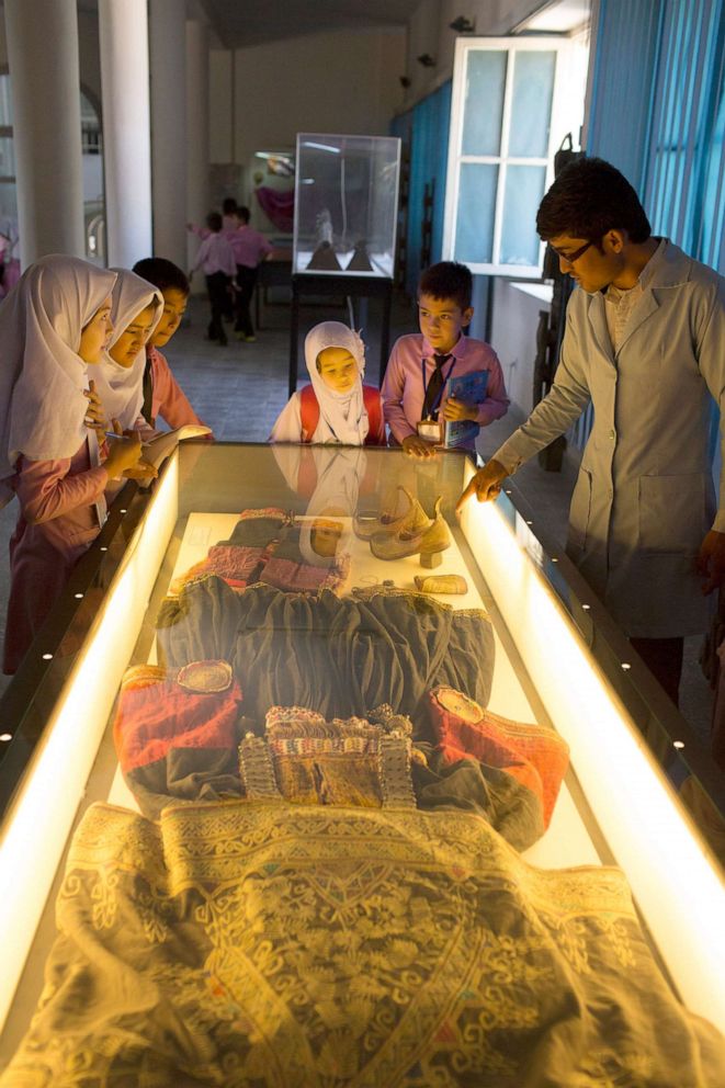 PHOTO: Schoolchildren gaze at one of the National Museum of Afghanistan's ethnographic displays, exhibiting the traditional dress, jewelry, and costumes worn by Afghanistan's many ethnicities, on Sept. 3, 2016 in Kabul.