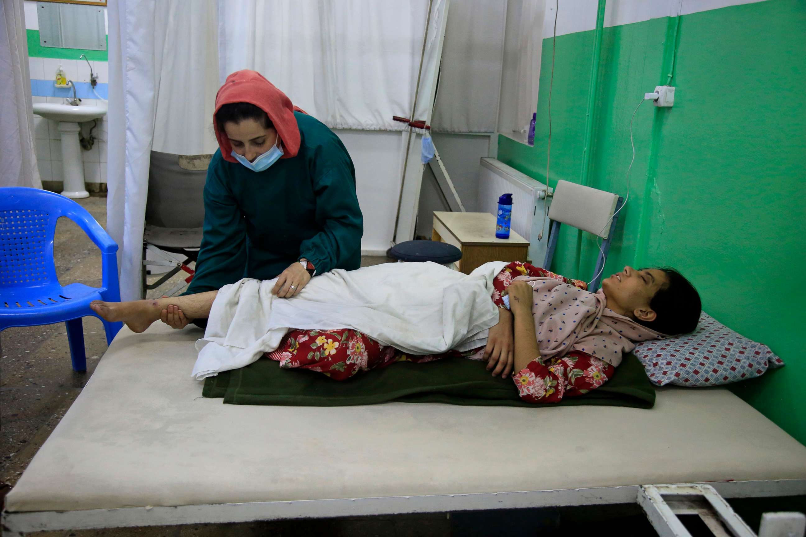 PHOTO: A girl receives medical care at the International Committee of the Red Cross (ICRC) physical rehabilitation center after being injured in fighting between the Taliban and Afghan security personnel, in Kabul, Afghanistan, Aug. 10, 2021