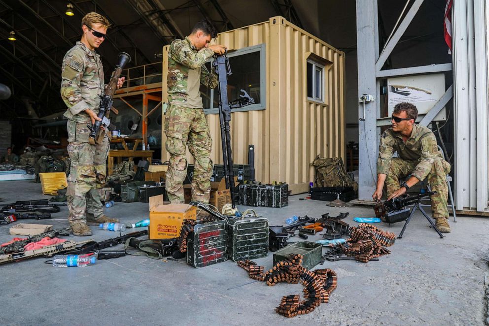 PHOTO: Paratroopers inspect weapons before de-militarizing them during a non-combatant evacuation operation in Kabul, Afghanistan, Aug. 25, 2021. 