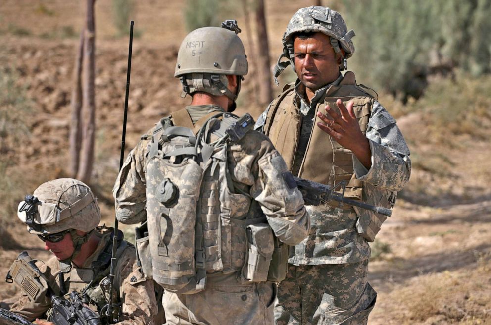 PHOTO: Translator Mohammed Shakir, of Afghanistan, translates for U.S. forces, during a U.S. Marine patrol in an area frequented by Taliban militants, in Nawa district, Helmand province, Afghanistan, Sept. 28, 2009.