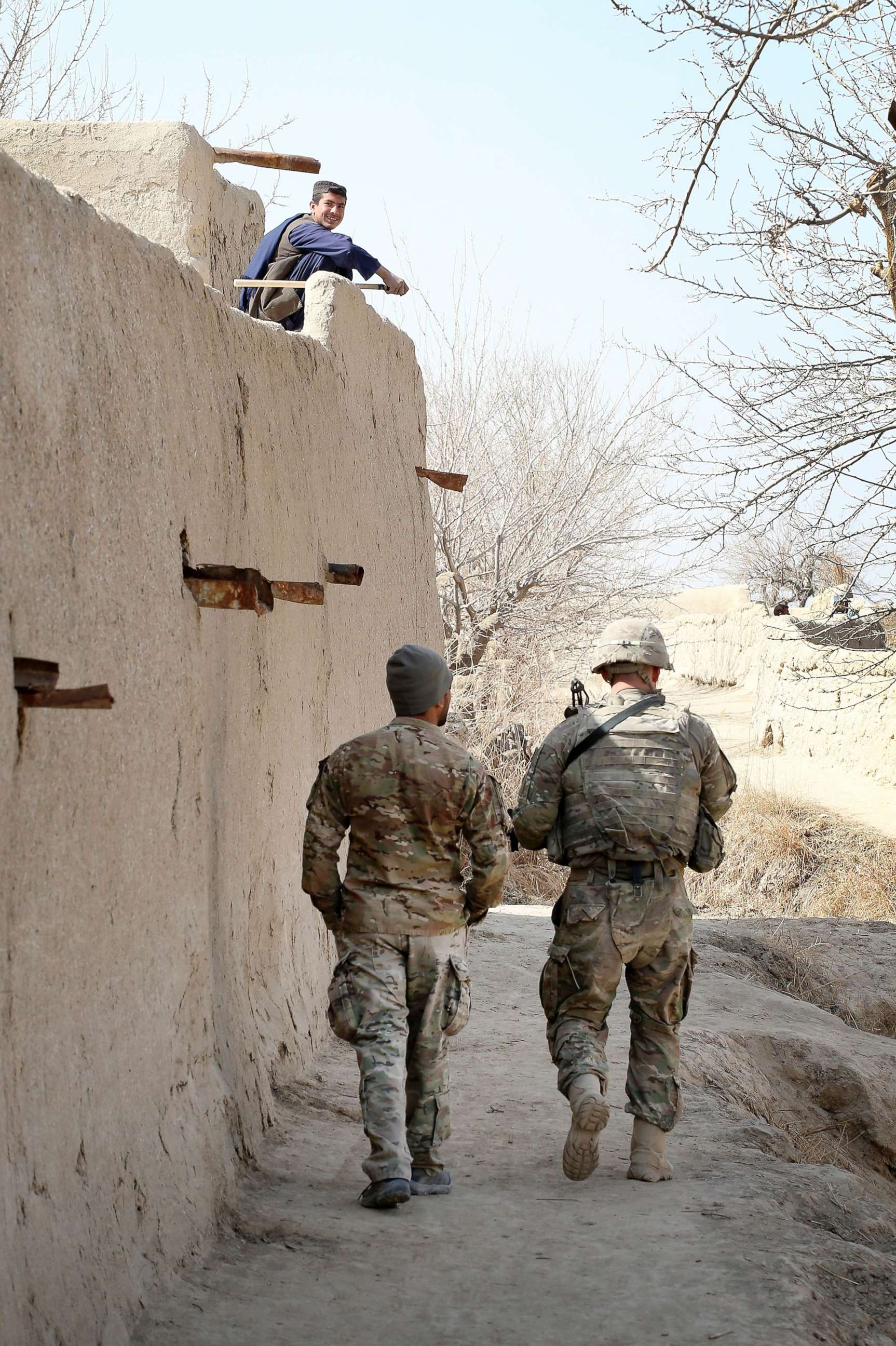 PHOTO: A 1st Lt. and his Afghan interpreter with the U.S. Army's 4th squadron 2d Cavalry Regiment patrol through a village near Kandahar, Afghanistan, Feb. 26, 2021.