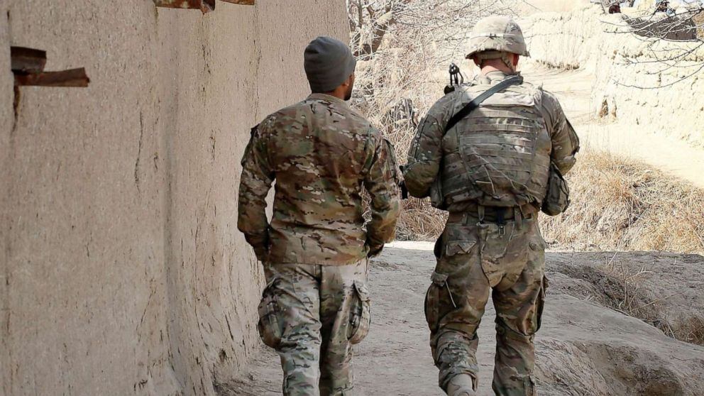 PHOTO: A 1st Lt. and his Afghan interpreter with the U.S. Army's 4th squadron 2d Cavalry Regiment patrol through a village near Kandahar, Afghanistan, Feb. 26, 2021.