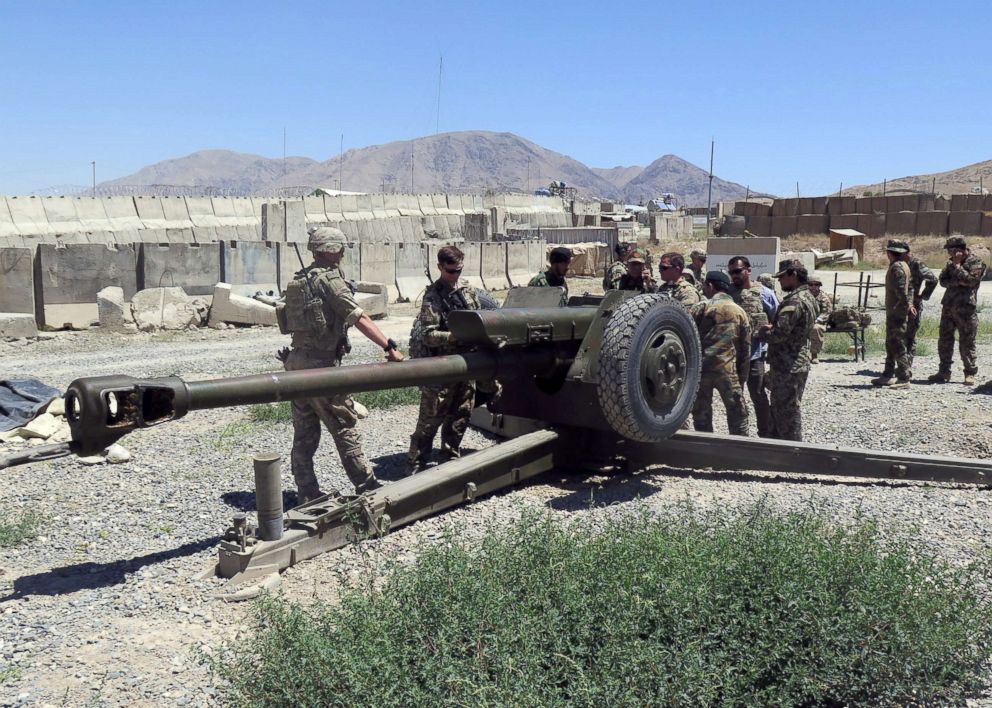 PHOTO: U.S. military advisers work with Afghan soldiers at an artillery position on an Afghan National Army base in Maidan Wardak province, Afghanistan, Aug. 6, 2018.