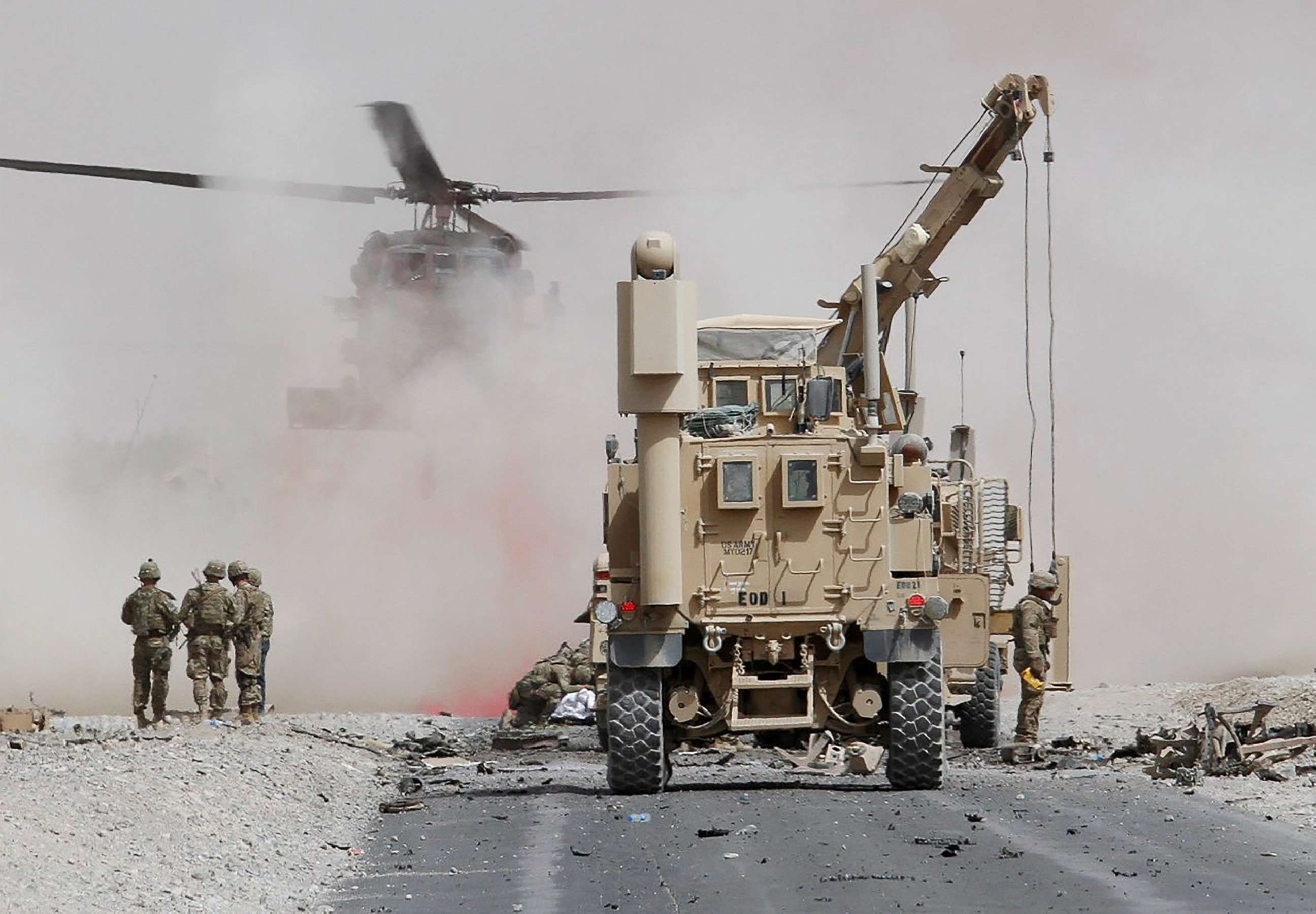 PHOTO: U.S. troops assess the damage to an armored vehicle of the NATO-led military coalition after a suicide attack in Kandahar province, Afghanistan, Aug. 2, 2017.