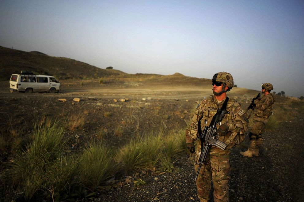 Members of the 1st Platoon Comanche Company of the U.S. Army stand at a checkpoint in the Combat Outpost Lakon in Buwri Tana District, Khost Province in Afghanistan on Aug. 9, 2012. 