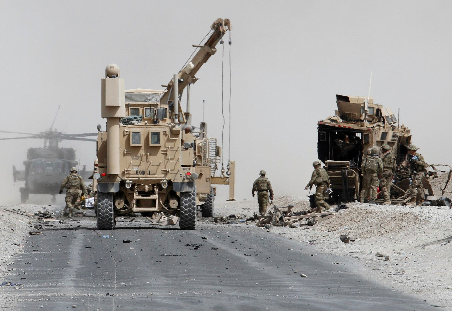 PHOTO: U.S. troops assess the damage to an armored vehicle of NATO-led military coalition after a suicide attack in Kandahar province, Afghanistan, in this Aug. 2, 2017, file photo.