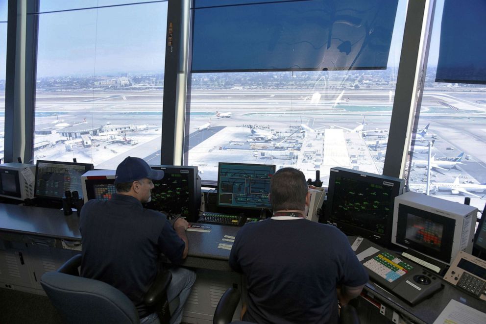 PHOTO: In this June 24, 2016, file photo, air traffic controllers talk with pilots inside the control tower at Los Angeles International Airport (LAX) in  Los Angeles.