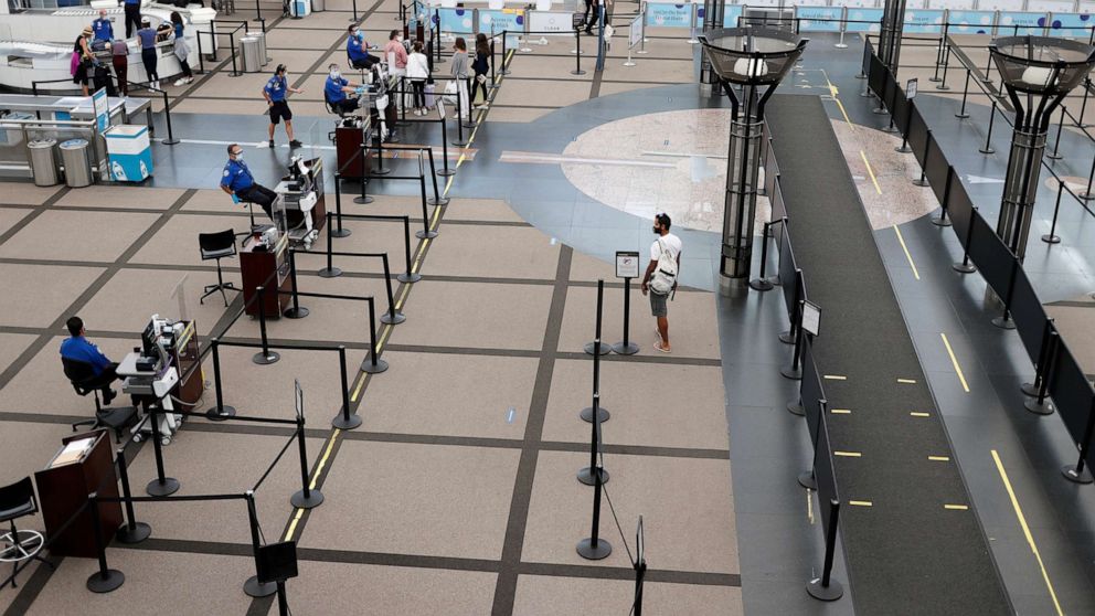 PHOTO: A traveler heads to the security checkpoint in the main terminal of Denver International Airport, July 22, 2020, in Denver.