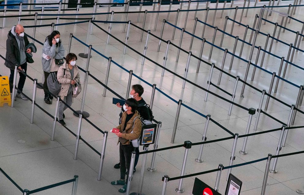 Passengers wait at the Terminal 1 section at John F. Kennedy International Airport, March 12, 2020 in New York.AFP via Getty Images, FILE