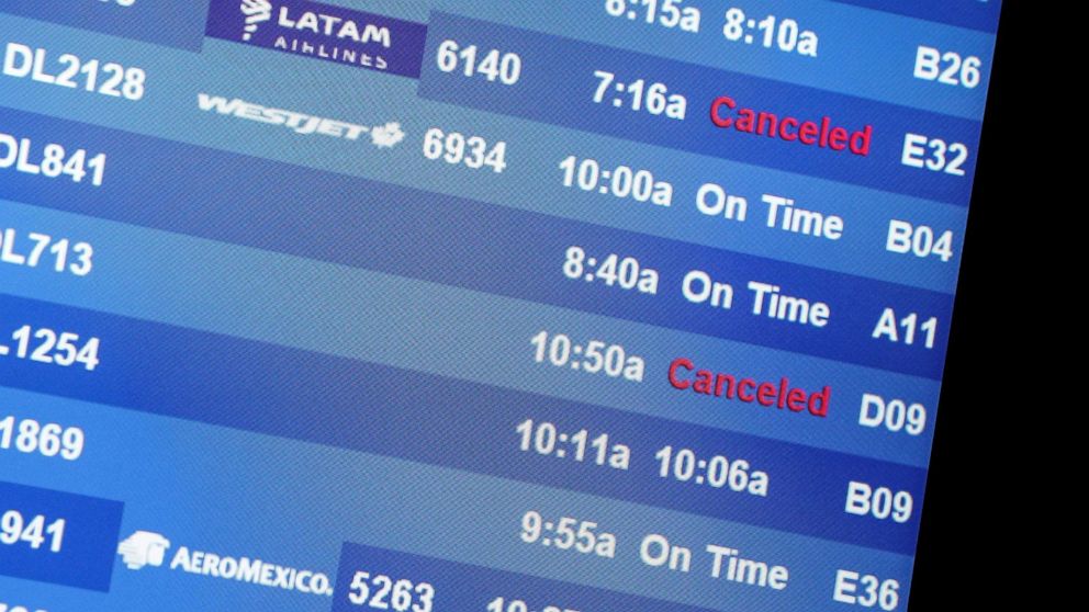 PHOTO: Two cancelled flights are seen on a monitor at the Delta Air Lines check-in counters at Hartsfield-Jackson Atlanta International Airport in Atlanta, July 1, 2022. 