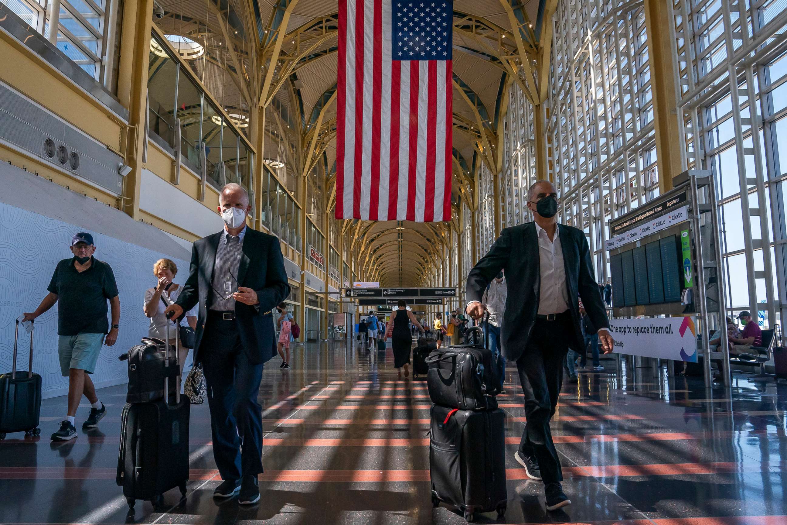 PHOTO: Travelers walk through Ronald Regan Washington National Airport, July 11, 2022, in Arlington, Va.