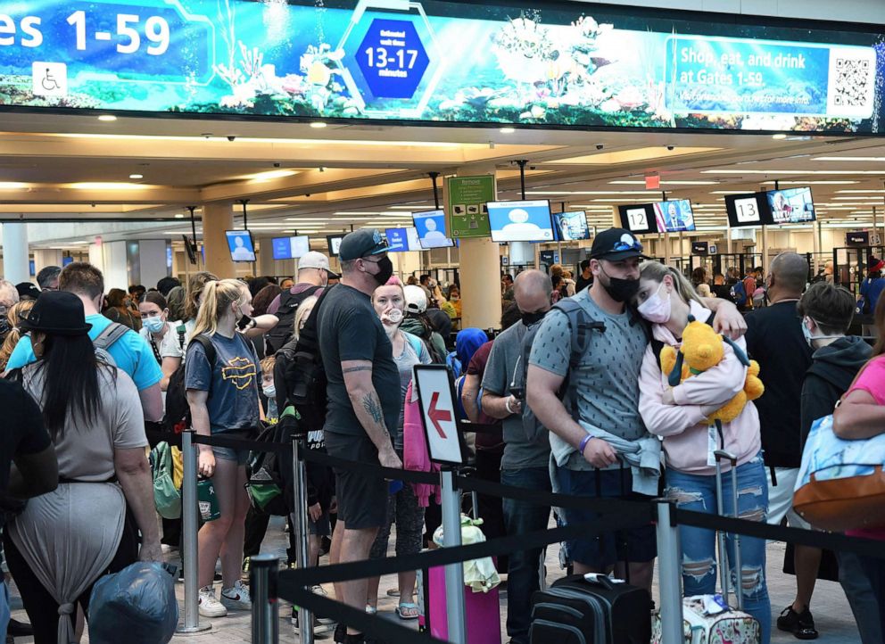 PHOTO: Spring break passengers wait in a TSA security line at Orlando International Airport in Orlando, March 19, 2022.