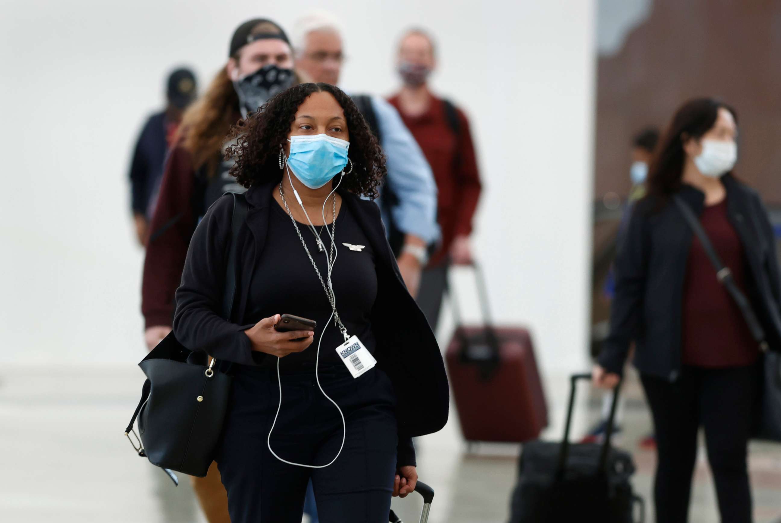 PHOTO: Passengers wear face masks as they enter the main terminal after arriving at Denver International Airport to stop the spread of the new coronavirus, April 23, 2020, in Denver.