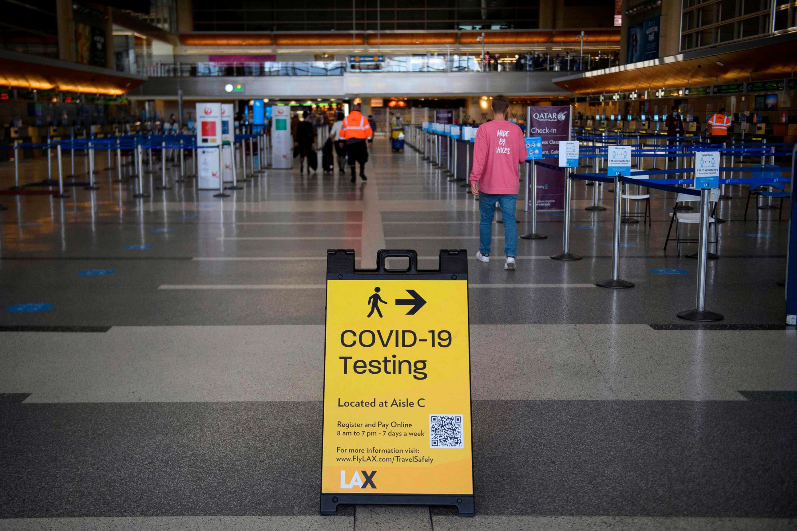 PHOTO: A sign directing people to Covid-19 testing is displayed by check-in counters at Los Angeles International Airport (LAX) amid increased Covid-19 travel restrictions, Jan. 25, 2021 in Los Angeles.