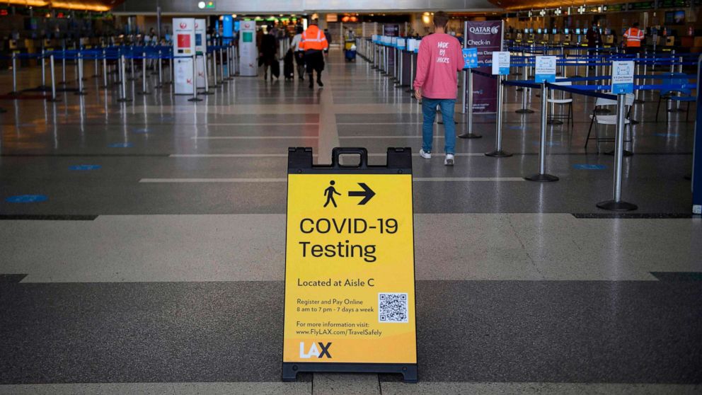PHOTO: A sign directing people to Covid-19 testing is displayed by check-in counters at Los Angeles International Airport (LAX) amid increased Covid-19 travel restrictions, Jan. 25, 2021 in Los Angeles.